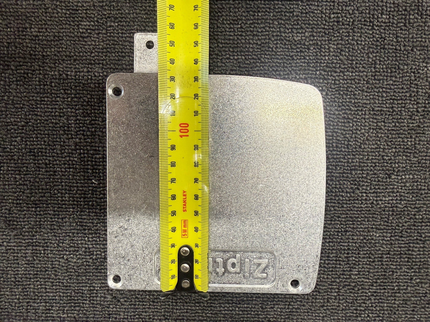 Ziptrak 135mm extruded pelmet side frame measured against a tape measure, height view