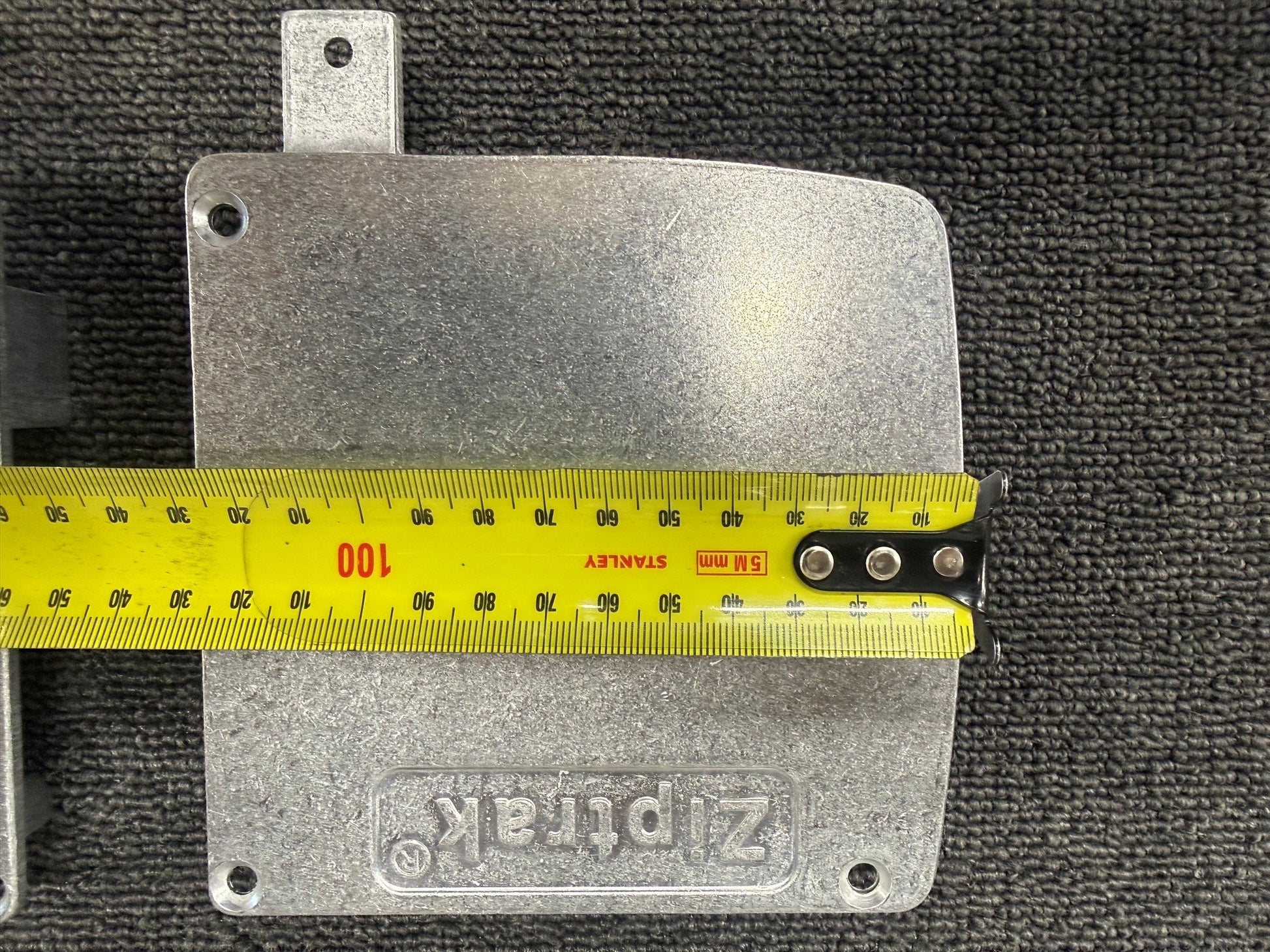 Ziptrak 135mm extruded pelmet side frame measured against a tape measure, width view